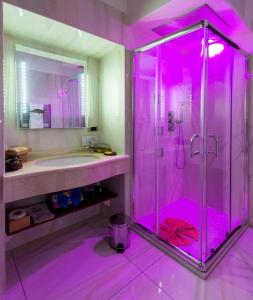 a pink bathroom with a shower and a sink at B&B Roma Royal Residence in Rome