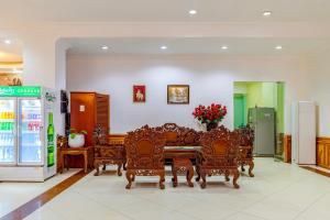 a dining room with a table and chairs and a refrigerator at Lisha Roungnakhone Hotel in Vang Vieng