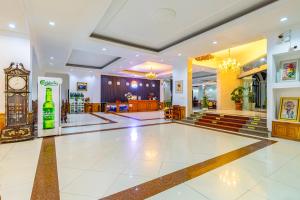 a large room with a clock and a lobby at Lisha Roungnakhone Hotel in Vang Vieng +60 photos