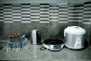 a kitchen counter with a toaster and plates of food at Greenery Garden in Idamegama