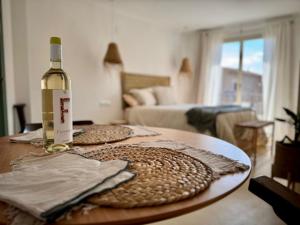 a bottle of wine sitting on top of a table at Casa Forta, charm between vines in Capmany
