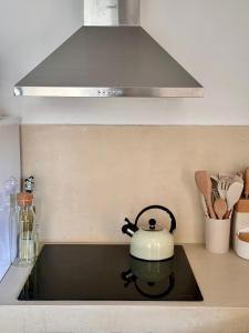 a tea kettle on a stove top in a kitchen at Casa Forta, charm between vines in Capmany +13 photos