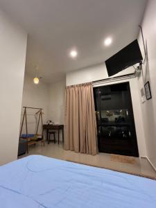 a bedroom with a bed and a large window at Villa The Quarry Segamat in Segamat