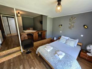a bedroom with a bed and a desk and a chair at Feel at home in Warre, Durbuy in Durbuy