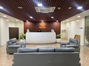 a lobby with couches and a table in a building at INSPIRIA 1803 Studio Unit with Balcony beside Abreeza Mall Davao in Davao City +17 photos