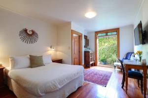 une chambre avec un lit, un bureau et une fenêtre dans l'établissement Abel Abode -Te Whare Rangi, à Nelson