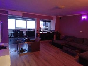 a living room with a couch and a dining room at Apartment D&J 2 in Mošćenička Draga