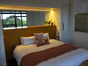 a bedroom with a large bed with a large window at Barossa Pavilions & Glasshouse in Lyndoch