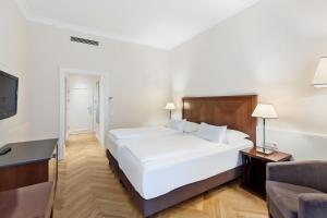 Кровать или кровати в номере Austria Trend Parkhotel Schönbrunn Wien