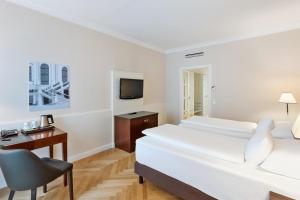 Кровать или кровати в номере Austria Trend Parkhotel Schönbrunn Wien