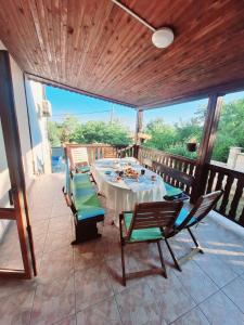a patio with a table and chairs on a deck at Villa Holly in Balchik
