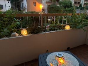 a table on a balcony with lights on it at Ferienwohnung Studio Bella Verde in Lesa