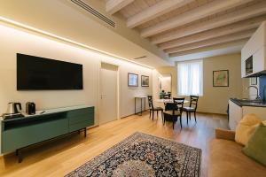 a living room with a couch and a flat screen tv at Palazzo Confalonieri da Lisca in Verona