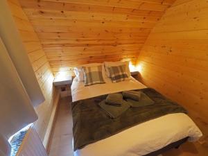 a bedroom with a bed in a wooden cabin at Orchard Hideaway, Bielby, York in Everingham