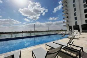 ein Swimmingpool auf einem Gebäude in der Unterkunft Lovely Waterfront Private 2BR Apartment Yas Island in Abu Dhabi