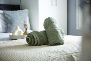 a rolled up towel on top of a bed at 34 Evesham Road - Studio Apartment in Shottery