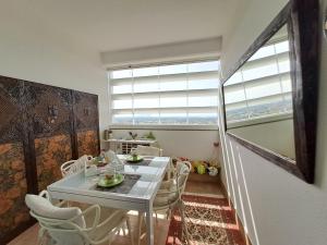 a dining room with a table and chairs and a window at CityView in Latina