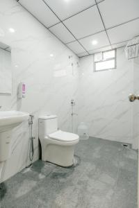 a white bathroom with a toilet and a sink at No 7 Vista in Bengaluru +24 photos