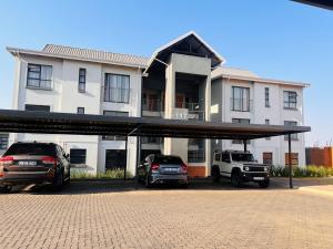 two cars parked in a parking lot in front of a building at Tetani's Luxury Oasis in Lakeside