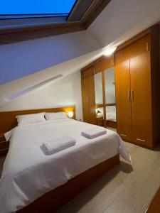 a bedroom with a large bed with two towels on it at Apartment in the Villa Northern Dreams #3 PARKING INCLUDED IN PRICE in Timişoara
