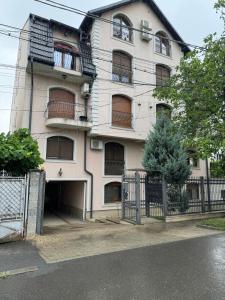 an apartment building with a garage in front of it at Apartment in the Villa Northern Dreams #3 PARKING INCLUDED IN PRICE in Timişoara