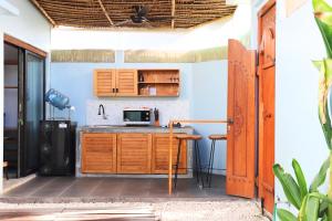 a kitchen with wooden cabinets and a counter top at Peacock Private Pool Villa, self check-in, Workspace, Kitchen in Dalung