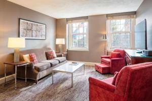 a living room with a couch and two chairs at Sheraton Commander Hotel in Cambridge