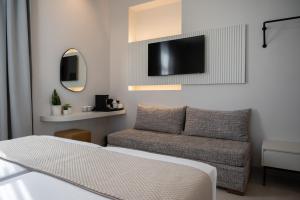 a living room with a couch and a flat screen tv at Palladion Boutique Hotel in Argos