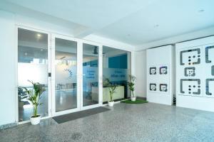 a room with plants and pictures on the walls at FlxHo Corporate - Golf Course Road in Gurgaon