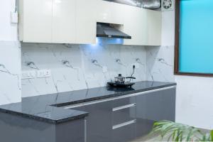 a kitchen with a counter with a tea kettle on it at FlxHo Corporate - Golf Course Road in Gurgaon +8 photos