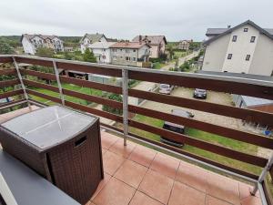 a balcony with a trashcan sitting on top of it at Złota 24 in Karwia