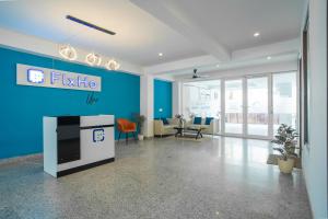 an office with a tv on a blue wall at FlxHo Corporate - Golf Course Road in Gurgaon