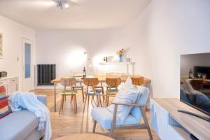 a living room with a couch and a table and chairs at Chic 3-BR Oasis in Ghent - Stylish Interiors in Ghent +13 photos