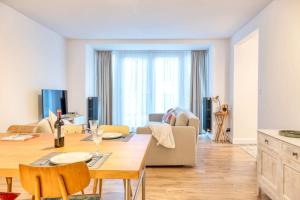 a living room with a table and a couch at Chic 3-BR Oasis in Ghent - Stylish Interiors in Ghent