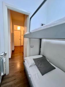 a small white room with a bed in it at CASA MIKI in Rapallo