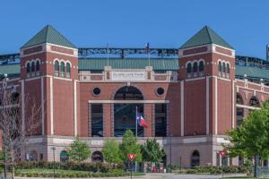 un grand bâtiment en briques avec un drapeau devant lui dans l'établissement Knights Inn - Forest Hill, TX, à Forest Hill