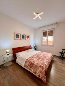 a bedroom with a bed and a ceiling fan at CASA MIKI in Rapallo +9 photos