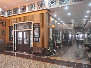 a lobby of a building with wooden walls and benches at Pearlmont Hotel in Camaman