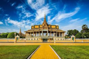 a building in a park with a blue sky at Essence Hotel-Phnom Penh in Phnom Penh