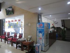 a restaurant with a soda machine and tables and chairs at Melody Viet Hotel in Ho Chi Minh City +86 photos