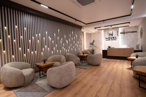 a waiting room with chairs and a wall with lights at Park Hotel Novel in Veliko Tŭrnovo