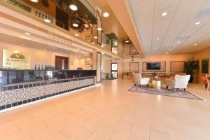 a lobby of a hospital with chairs and a bar at Americas Best Value Inn & Suites Victoria in Victoria
