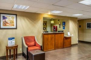 a waiting room with a chair and a desk at Comfort Inn Tucson Central in Tucson +105 photos