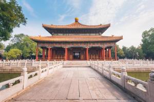 an asian building with a bridge in front at Fujian Hotel in Beijing