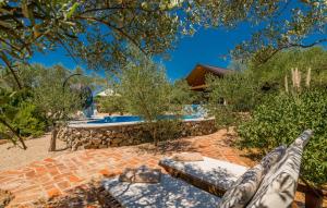 a view of a backyard with a pool and trees at House with pool, 50 meters from sea, privacy - by TRAVELER tourist agency Krk - ID 2137 in Kornić