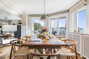 een eetkamer met een houten tafel en stoelen bij Ferienhaus BREEZE 71 Kappeln in Kappeln