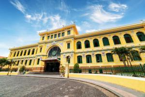 a large yellow building with a street in front of it at 95 Lam Son Hotel in Ho Chi Minh City