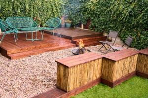 a garden with a fire pit and a table and chairs at Chic Family Home with Garden Fire Pit & Event Space, Hot Tub in Manchester +40 photos