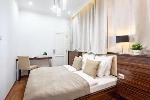 a bedroom with a white bed and a desk and window at Ultra Central - Balcony - Sunny in Budapest
