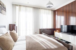 a bedroom with a bed and a flat screen tv at Ultra Central - Balcony - Sunny in Budapest